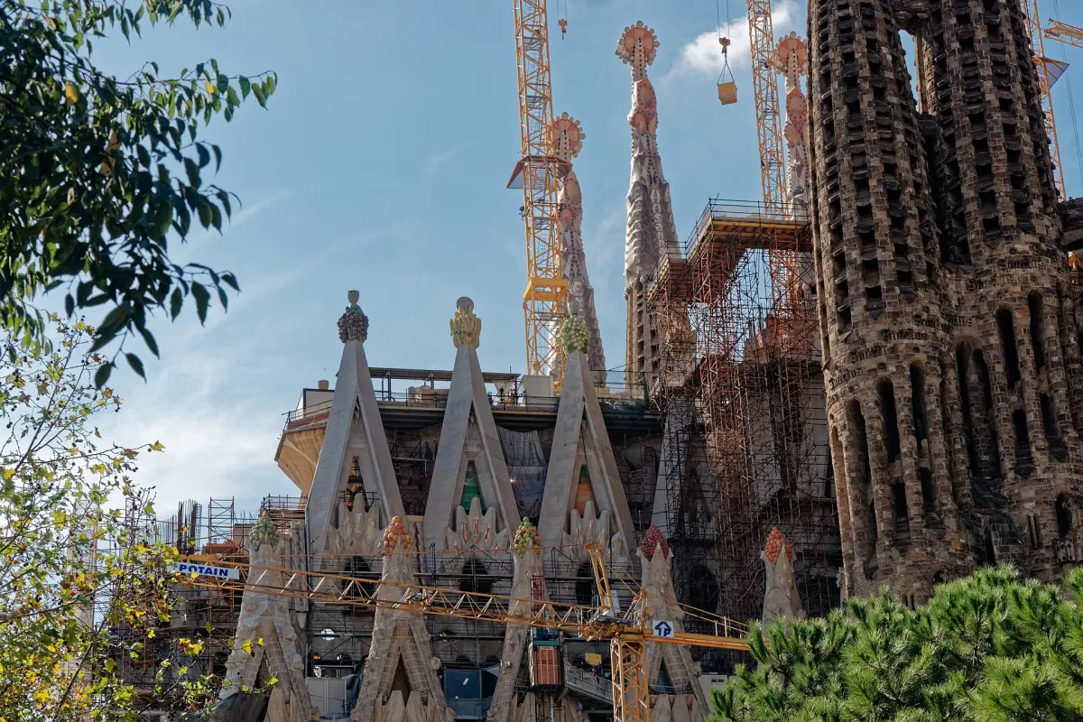 The Sagrada Família with cranes, seen from Plaça de Gaudí